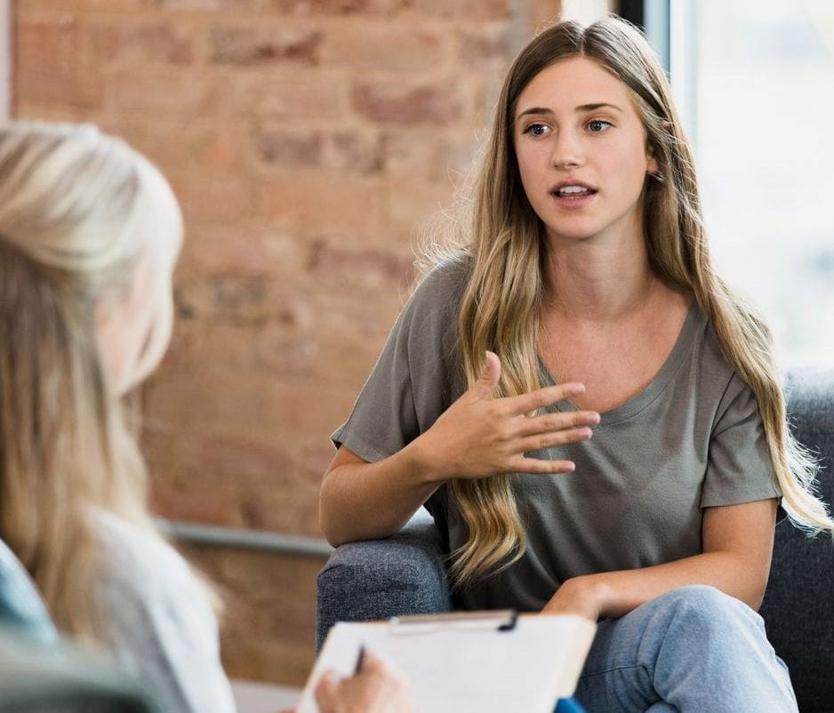 Female client gestures while talking to therapist