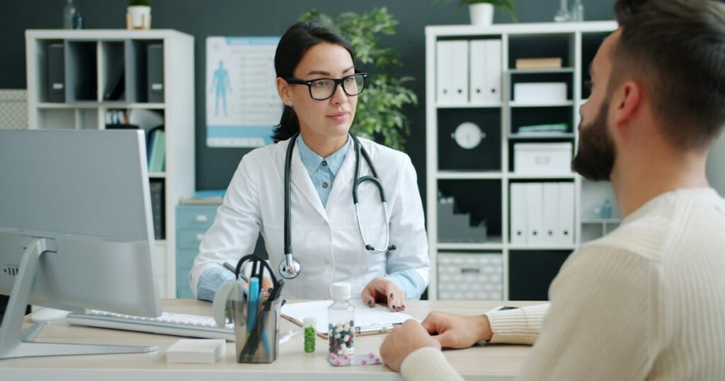 Psychiatrist reviewing medication options with an adult patient during a consultation